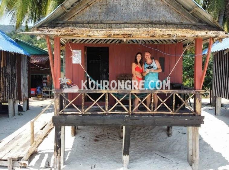 a couple on the balcony of the bungalow of the beach resort business for rent in sok san beach cambodia