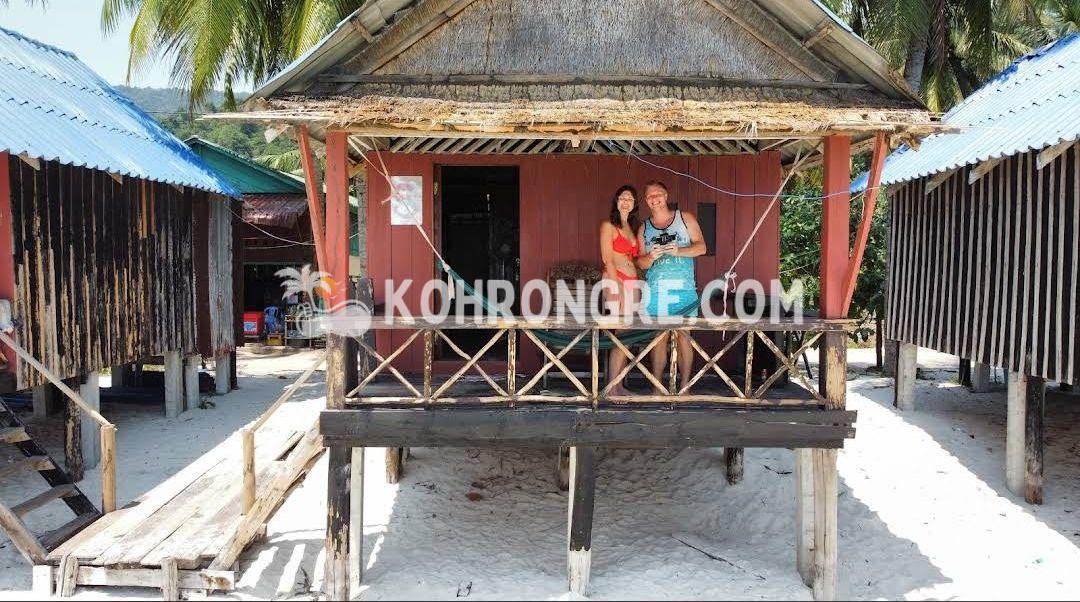a couple on the balcony of the bungalow of the beach resort business for rent in sok san beach cambodia